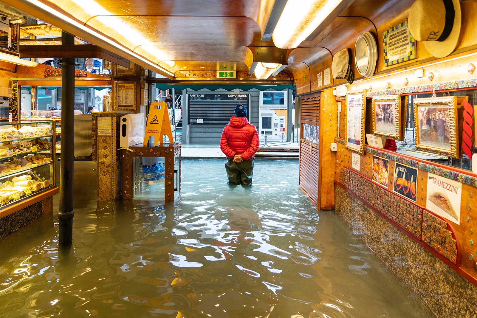 Owner-standing-in-flooded-business-covered-by-a-commercial-flood-insurance-policy